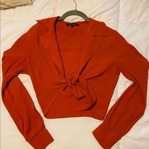 Burnt orange long sleeve wrap shirt.